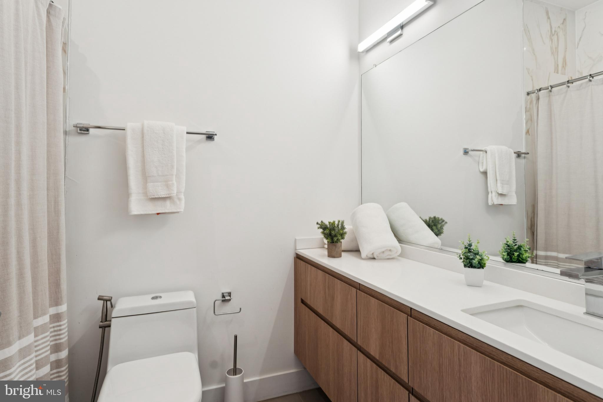4017 Davis Place Northwest, Unit 7 Washington, DC 20007 - Photo 27 of 39 a bathroom with a granite countertop sink and a toilet