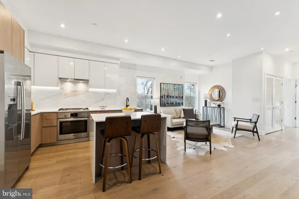 a kitchen with a stove a sink and a refrigerator