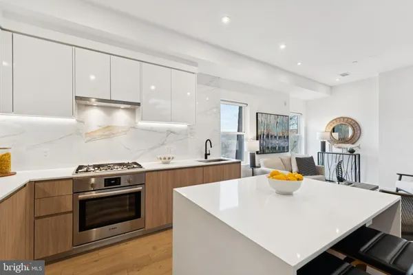 a kitchen with stainless steel appliances a sink a stove and refrigerator