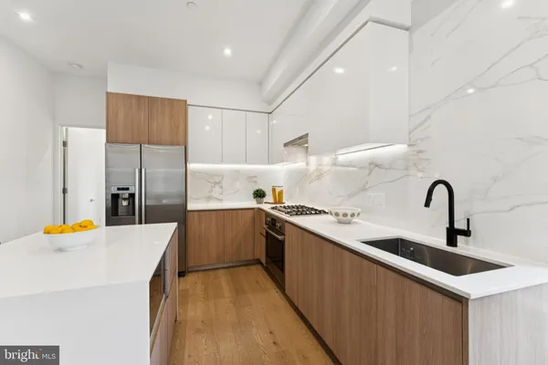 a kitchen with a table chairs stove and cabinets