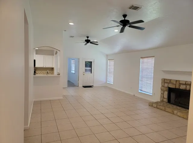 a view of an empty room and a fireplace