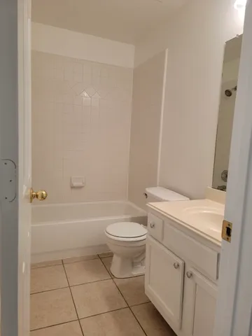 a white toilet sitting next to a bath tub