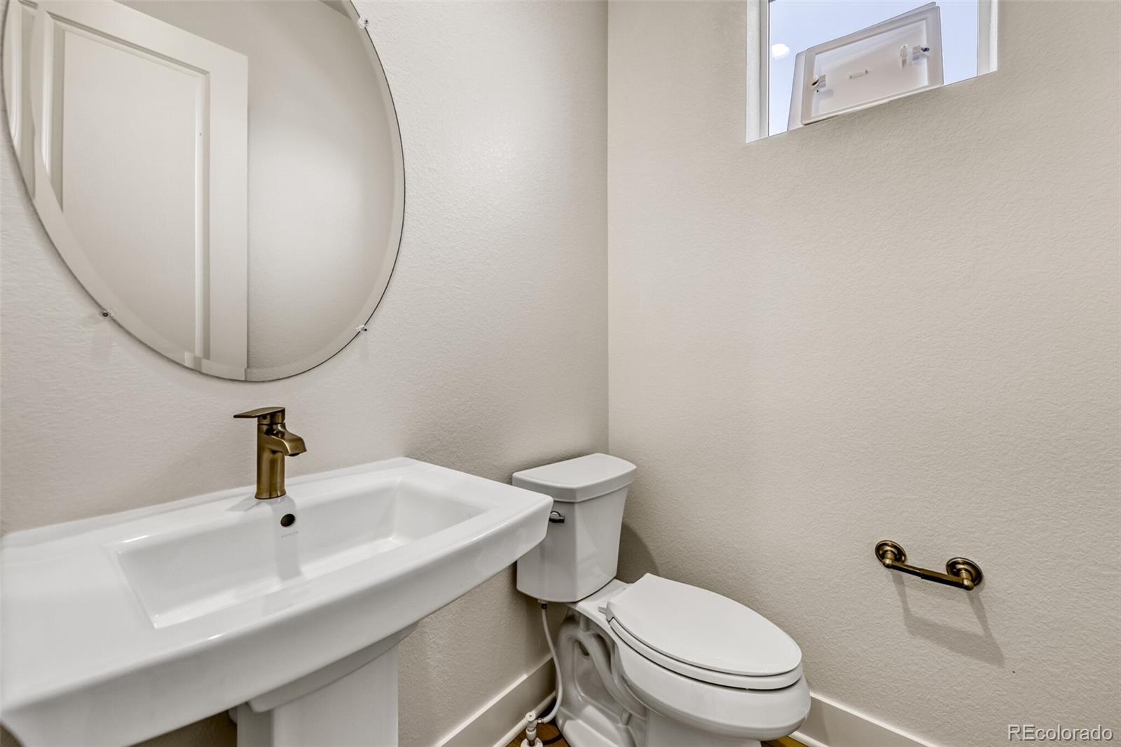 665 Skyhook Street Erie, CO 80516 - Photo 4 of 20 a bathroom with a sink a toilet and a mirror