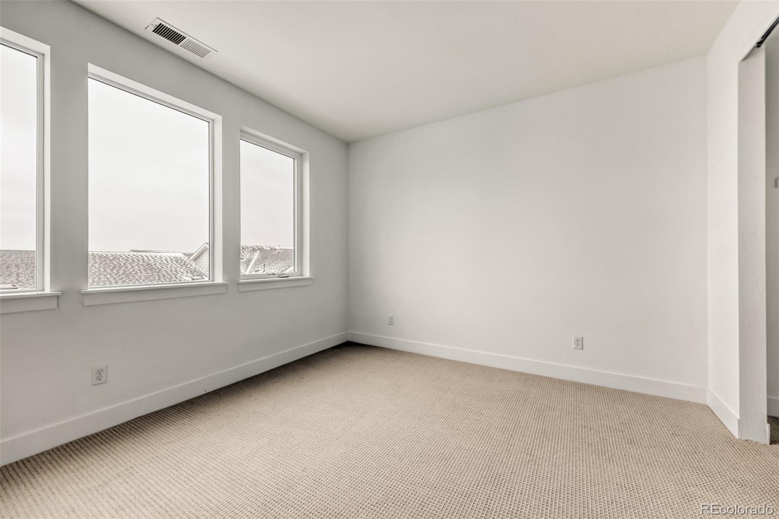 665 Skyhook Street Erie, CO 80516 - Photo 7 of 20 an empty room with a window