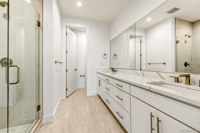 a spacious bathroom with a granite countertop sink mirror and double