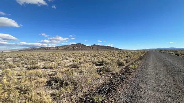 a view of an ocean beach and mountain