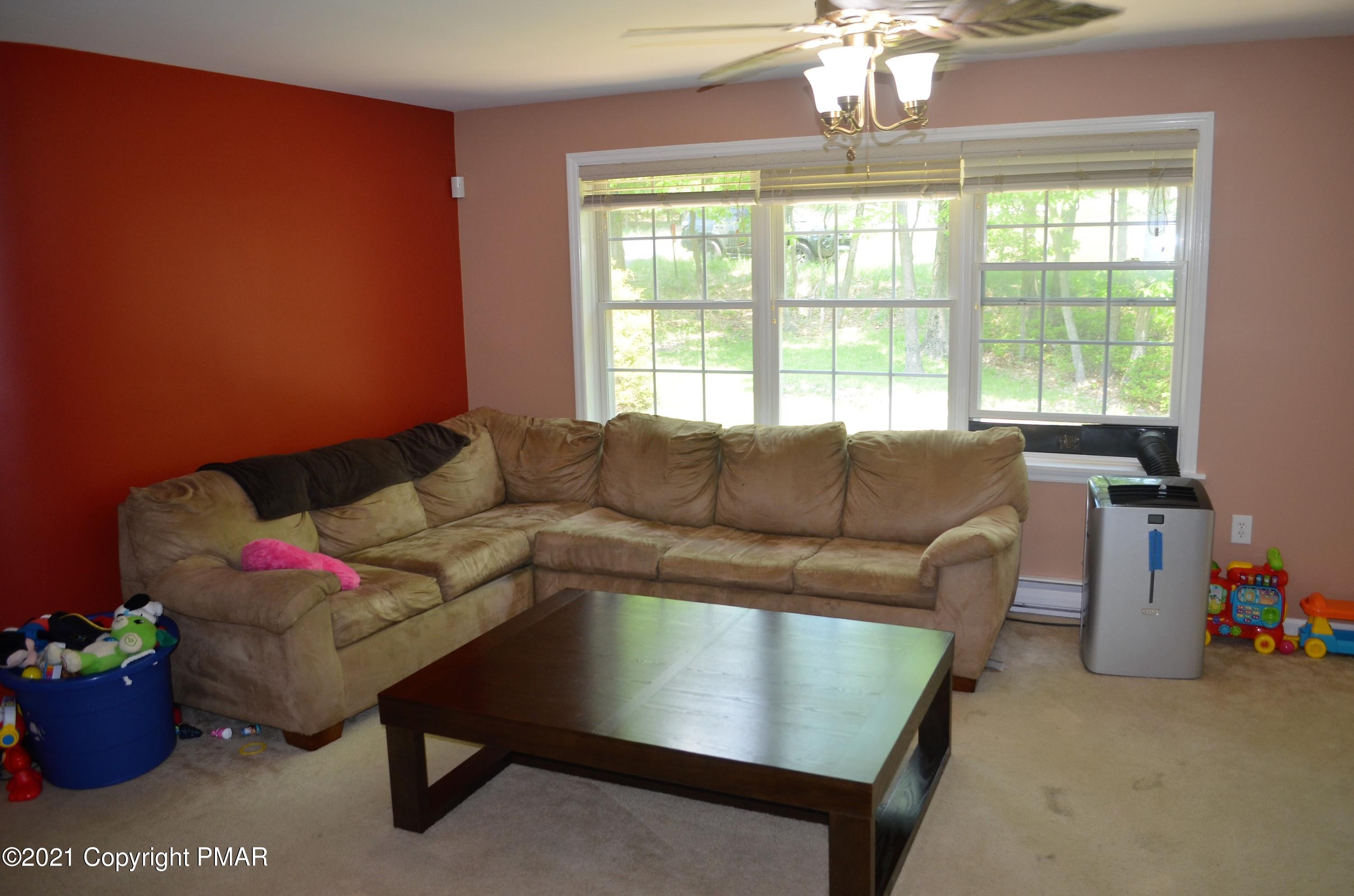 218 Nosirrah Road Albrightsville, PA 18210 - Photo 4 of 32 a living room with furniture and a chandelier