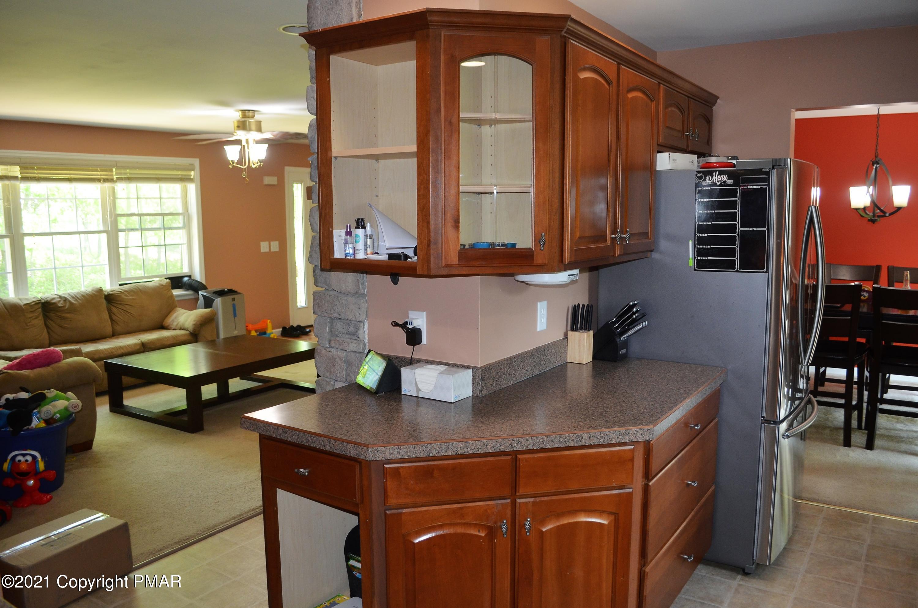 218 Nosirrah Road Albrightsville, PA 18210 - Photo 9 of 32 a living room with stainless steel appliances kitchen island granite countertop a table chairs in it and a large window