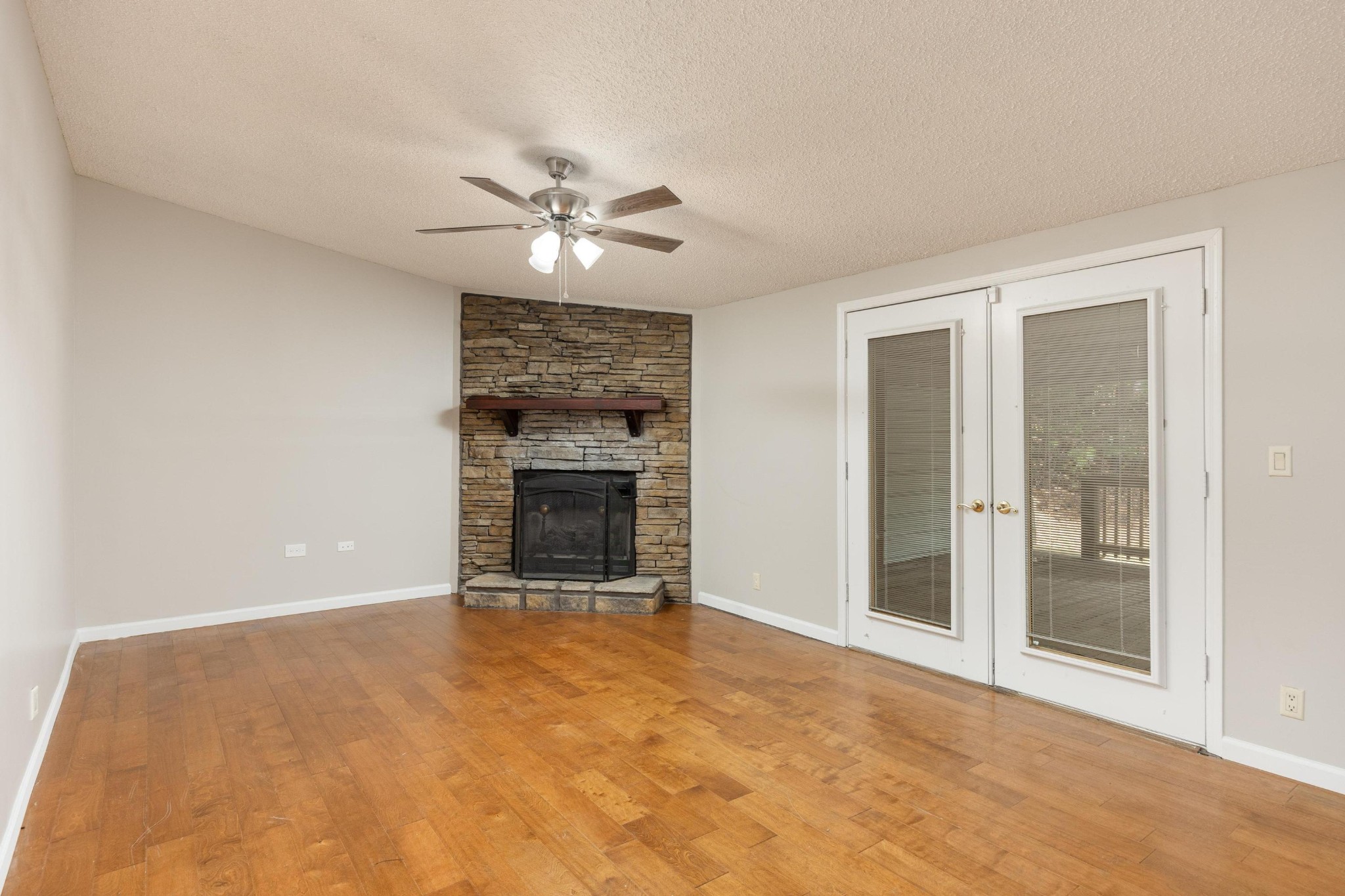 339 Oak Tree Road Ringgold, GA 30736 - Photo 12 of 31 an empty room with a fireplace and ceiling fan