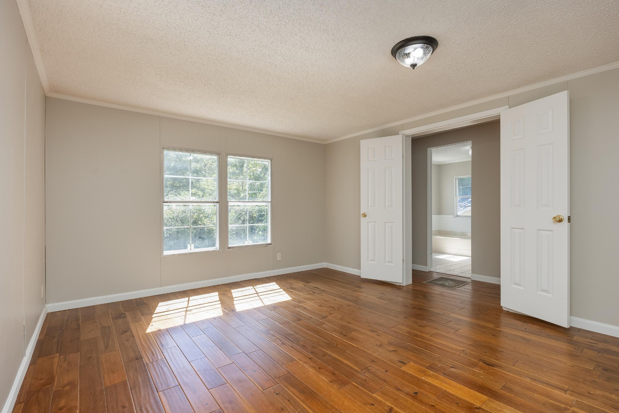 339 Oak Tree Road Ringgold, GA 30736 - Photo 19 of 31 an empty room with wooden floor and windows