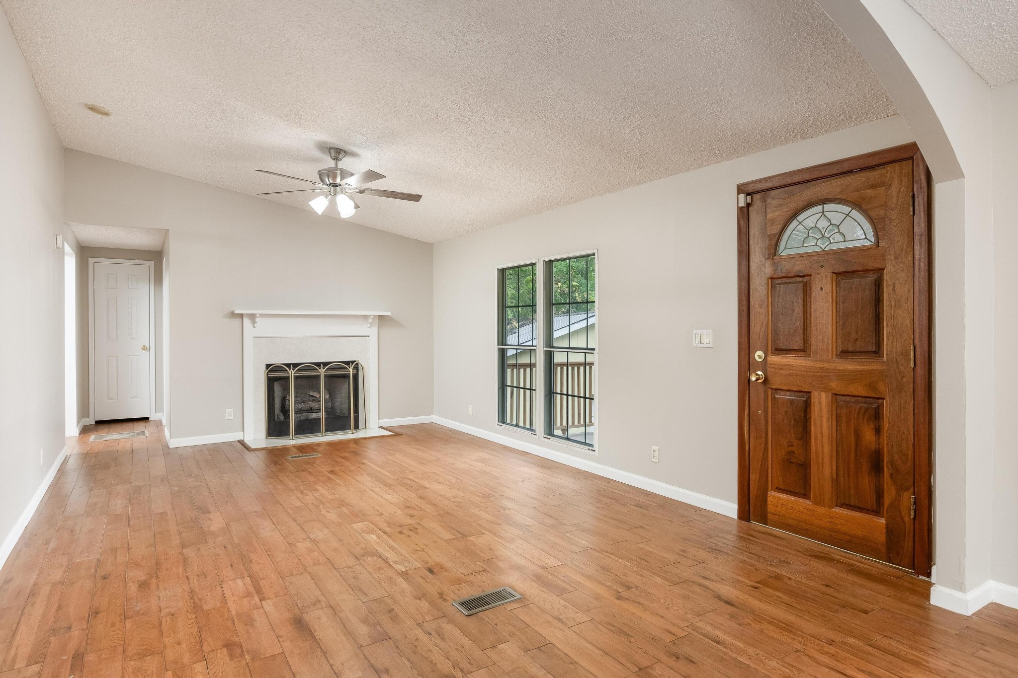 339 Oak Tree Road Ringgold, GA 30736 - Photo 3 of 31 an empty room with windows fireplace and a kitchen