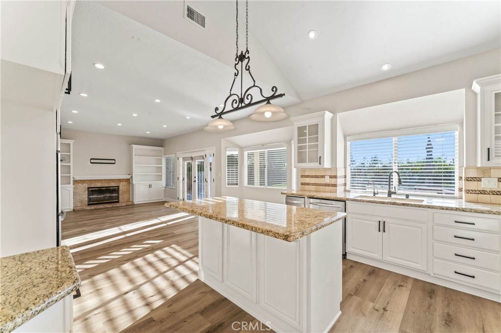 28241 Tamarack Lane Saugus, CA 91390 - Photo 12 of 41 a large white kitchen with granite countertop a stove and a sink