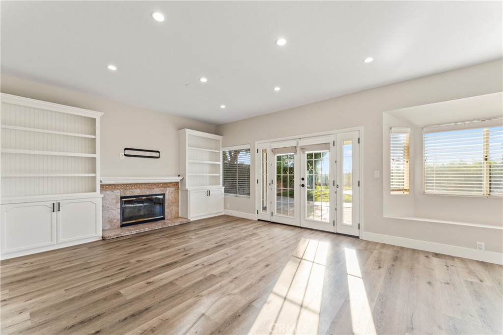 28241 Tamarack Lane Saugus, CA 91390 - Photo 15 of 41 wooden floor fireplace and windows in an empty room