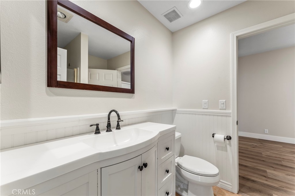 28241 Tamarack Lane Saugus, CA 91390 - Photo 16 of 41 a bathroom with a toilet a sink and mirror