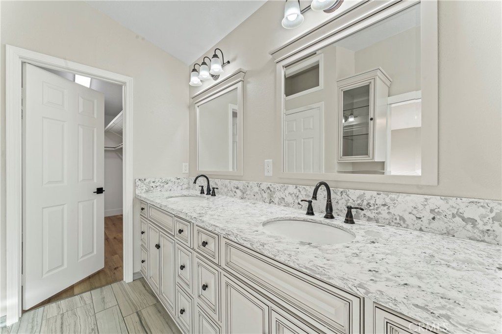 28241 Tamarack Lane Saugus, CA 91390 - Photo 21 of 41 a bathroom with a granite countertop double vanity sink and mirror
