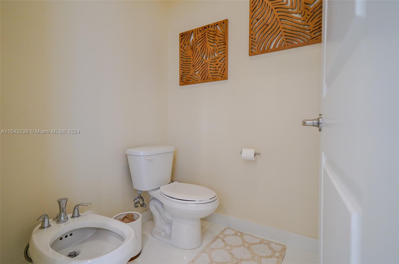 14570 Southwest 19th Street Miami, FL 33175 - Photo 15 of 30 a bathroom with a toilet sink and mirror