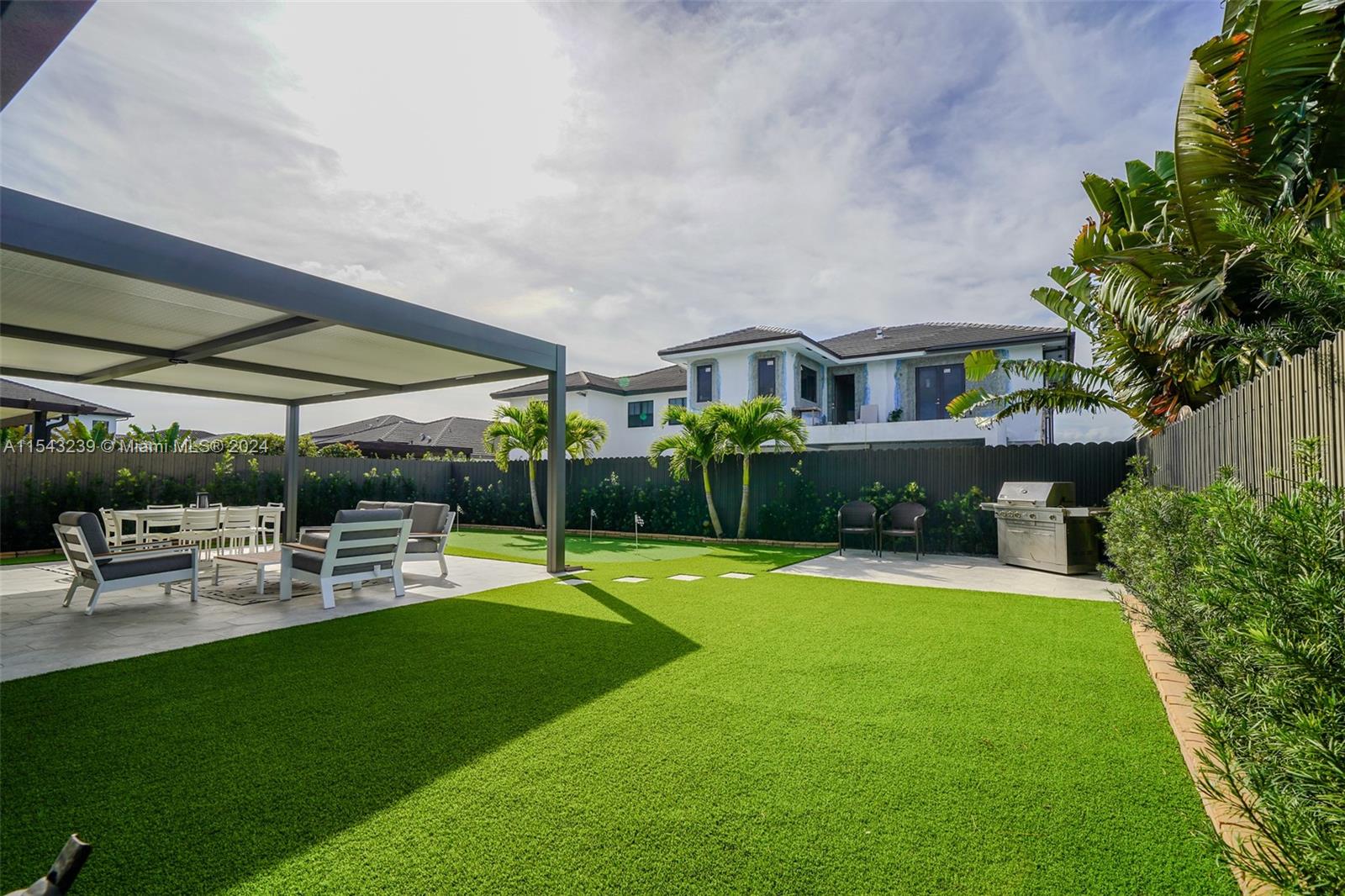 14570 Southwest 19th Street Miami, FL 33175 - Photo 28 of 30 a view of a patio with a table and chairs under an umbrella