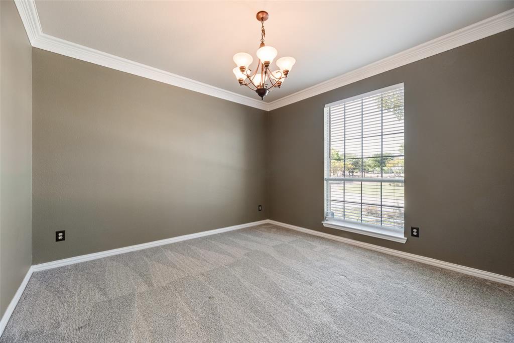 11104 Rogers Road Frisco, TX 75033 - Photo 34 of 40 Unfurnished room with crown molding, suspended lighting, and light carpet