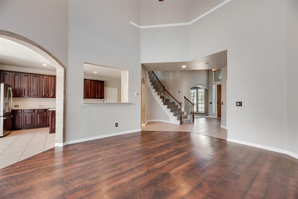 11104 Rogers Road Frisco, TX 75033 - Photo 4 of 40 Unfurnished living room with arched walkways, light wood-style flooring, and recessed lighting