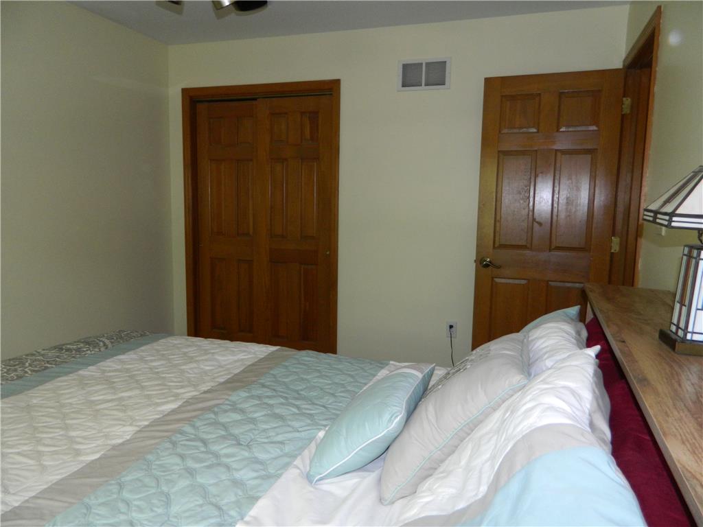 328 Pin Oak Road Stroudsburg, PA 18360 - Photo 33 of 37 Comfortable bedroom with natural wood doors and ample space for rest and relaxation.