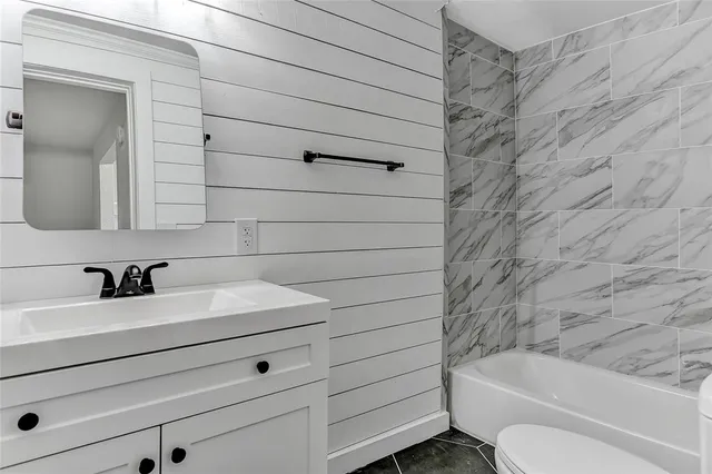 a bathroom with a sink toilet and tub