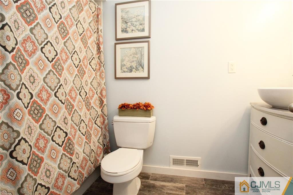 16 Ridge Road Old Bridge, NJ 08857 - Photo 11 of 22 a white toilet sitting next to a shower curtain