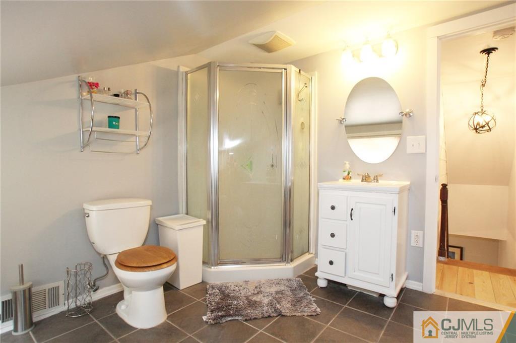 16 Ridge Road Old Bridge, NJ 08857 - Photo 16 of 22 a bathroom with a toilet sink and a mirror