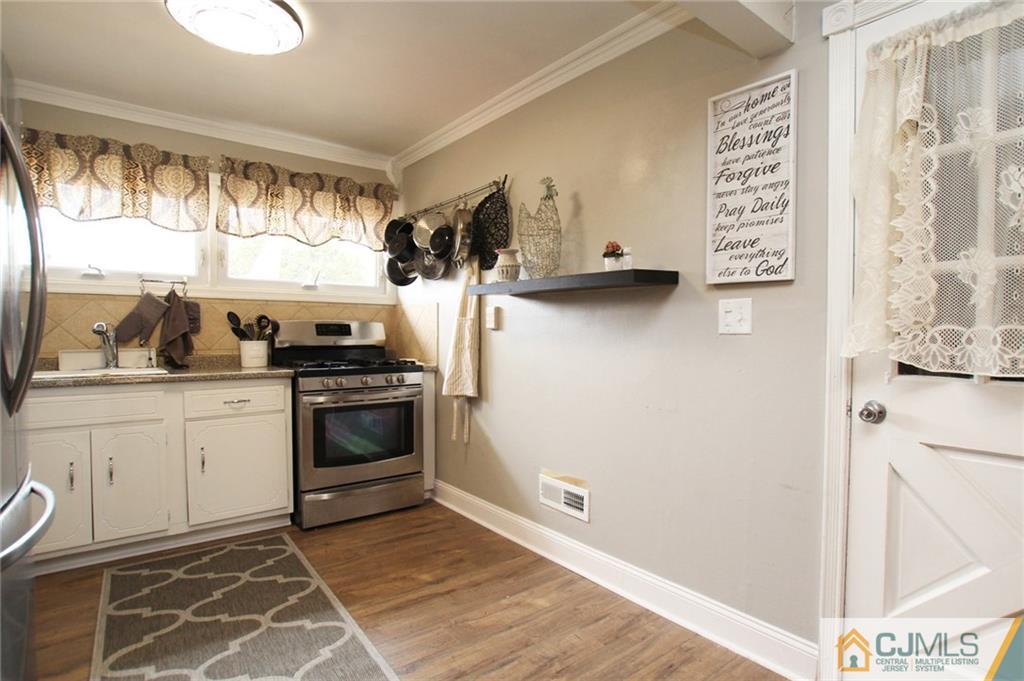 16 Ridge Road Old Bridge, NJ 08857 - Photo 3 of 22 a kitchen with a stove and a white refrigerator