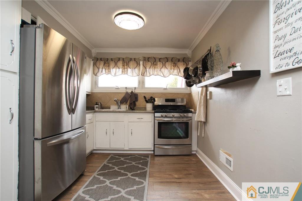 16 Ridge Road Old Bridge, NJ 08857 - Photo 4 of 22 a kitchen with stainless steel appliances granite countertop a refrigerator and a stove