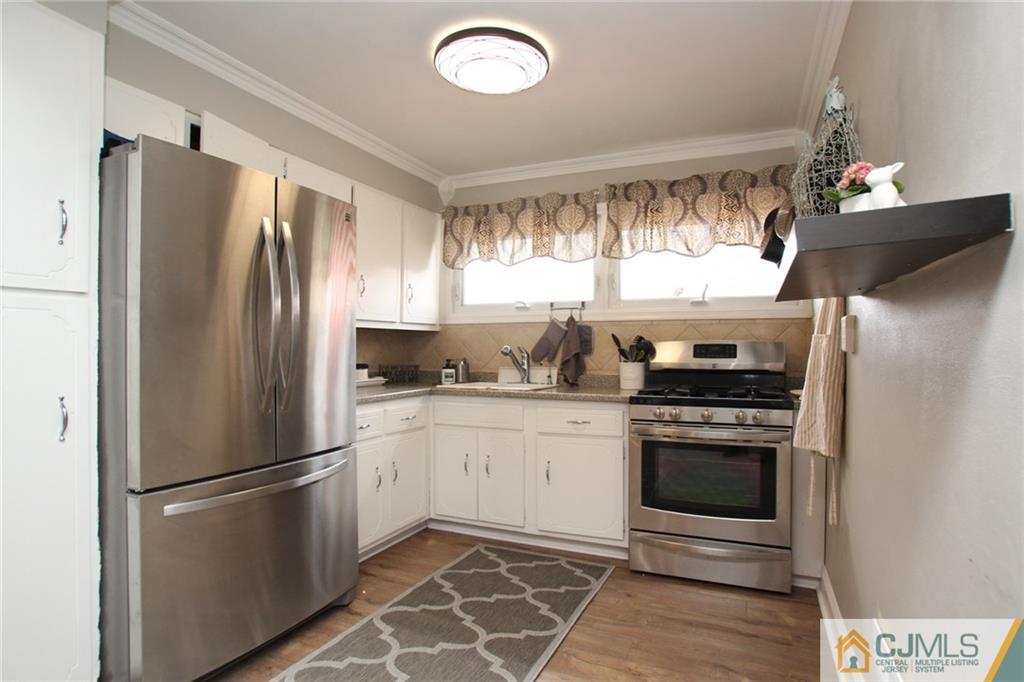 16 Ridge Road Old Bridge, NJ 08857 - Photo 5 of 22 a kitchen with stainless steel appliances granite countertop a refrigerator sink and stove