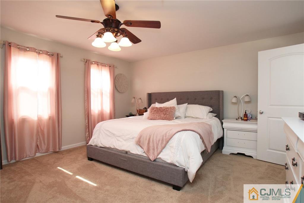 16 Ridge Road Old Bridge, NJ 08857 - Photo 9 of 22 a bedroom with a bed and a chandelier