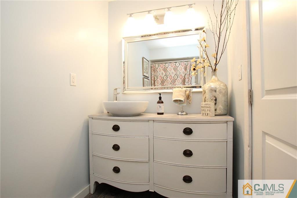 16 Ridge Road Old Bridge, NJ 08857 - Photo 10 of 22 a bathroom with a tub sink and mirror