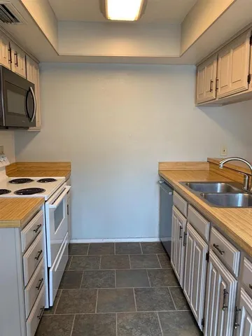 a utility room with cabinets washer and dryer