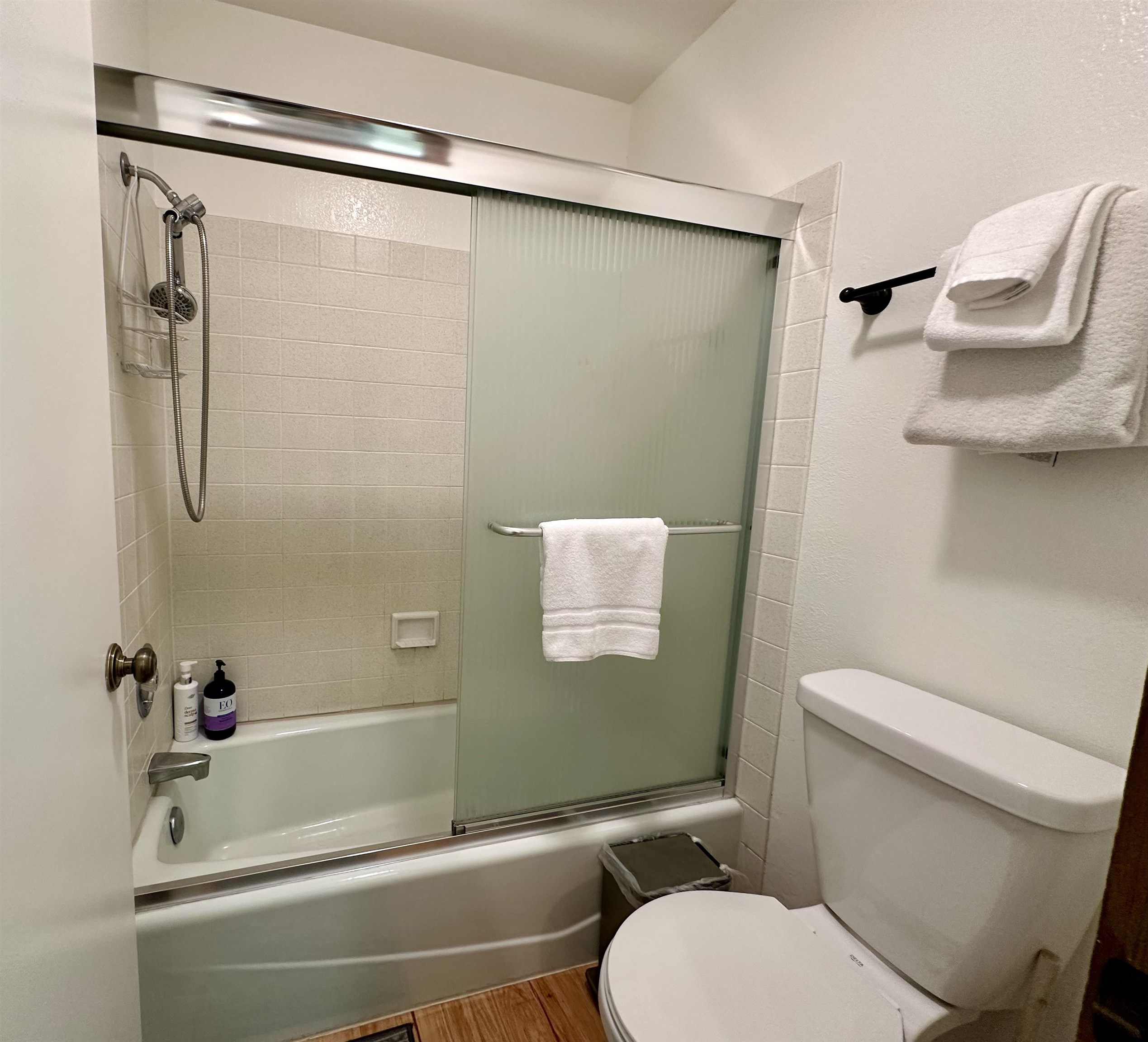 315 Fascination, Unit 315 Mammoth Lakes, CA 93546 - Photo 20 of 44 Bathroom featuring a shower-over-tub combination with tile surround, sliding frosted glass doors, and a chrome shower head