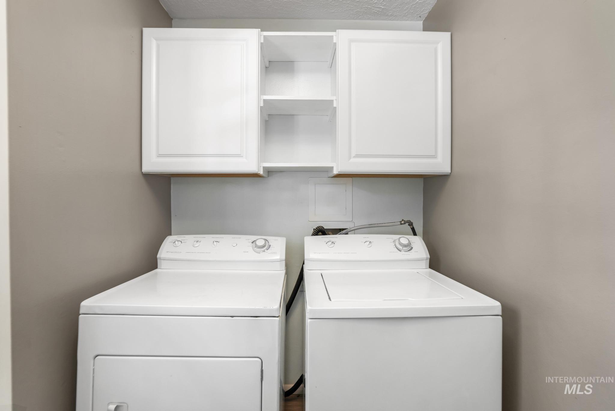 712 Locust Street Kimberly, ID 83341 - Photo 12 of 26 Kitchen featuring wood-finish cabinetry, a double basin stainless steel sink, a brushed nickel faucet, light-toned countertops, and white subway tile backsplash