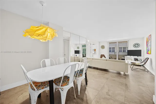 a view of a dining room with furniture and a potted plant