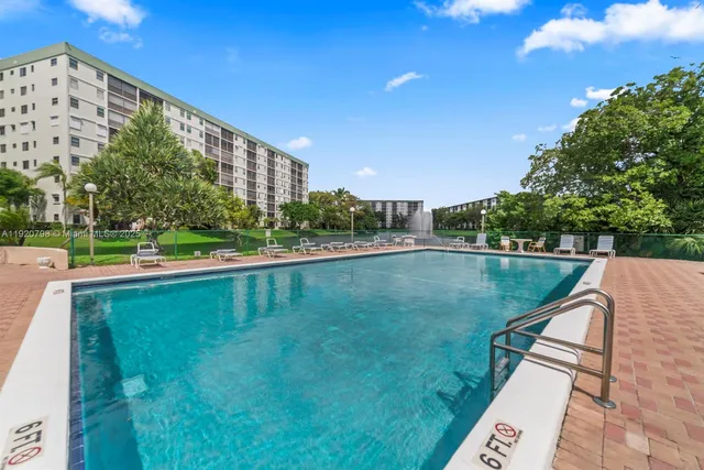 a view of swimming pool with a yard and plants