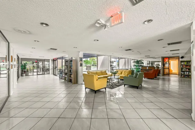 a living room with patio furniture and a chandelier