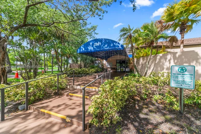 a view of a backyard with a table and chairs potted plants