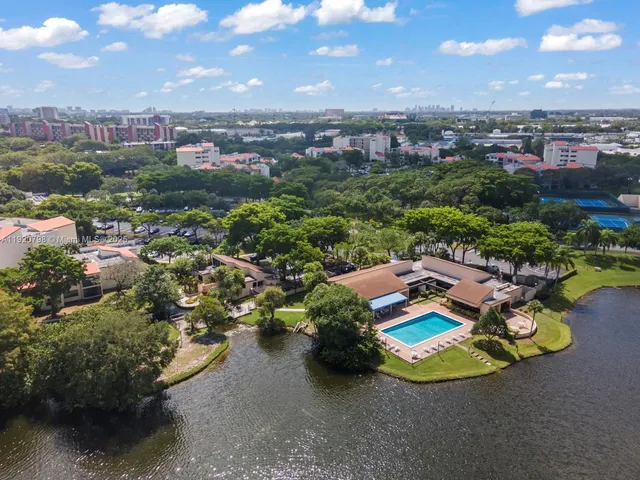 an aerial view of a house with a garden and lake view