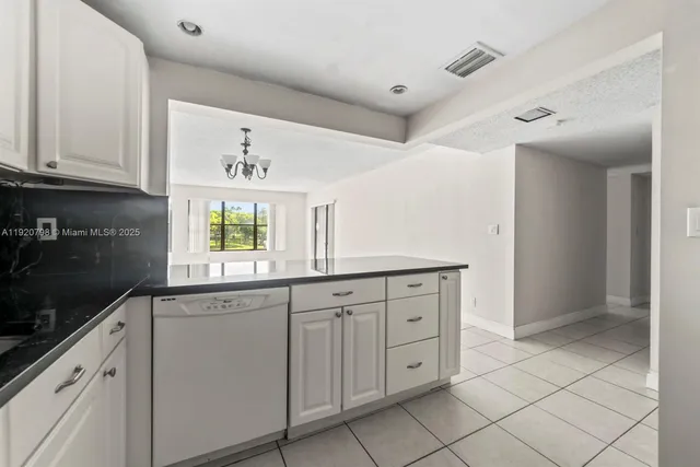 a kitchen with white cabinets