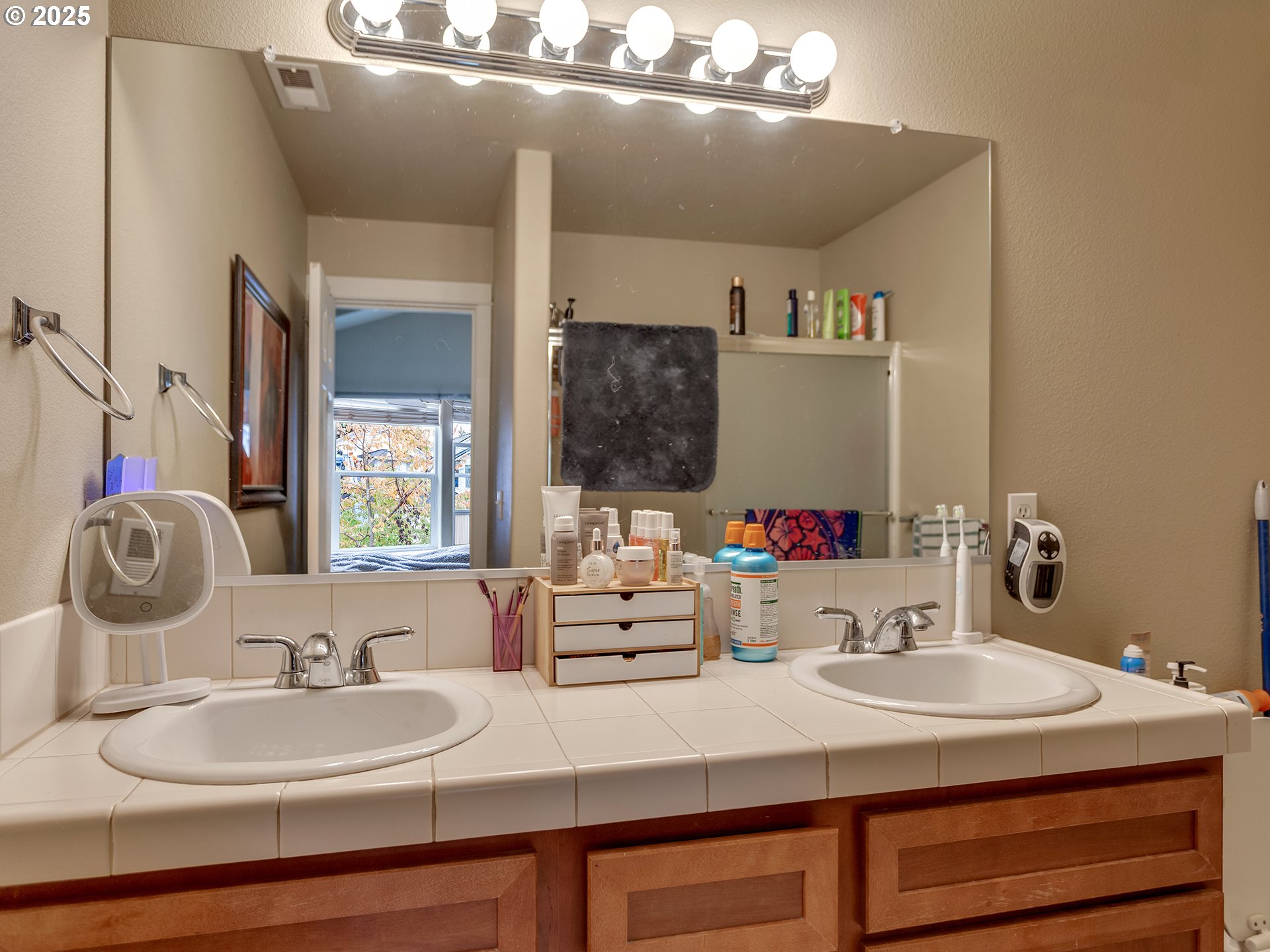 7817 Southwest Brookline Lane Portland, OR 97224 - Photo 13 of 13 a bathroom with a double vanity sink and a mirror