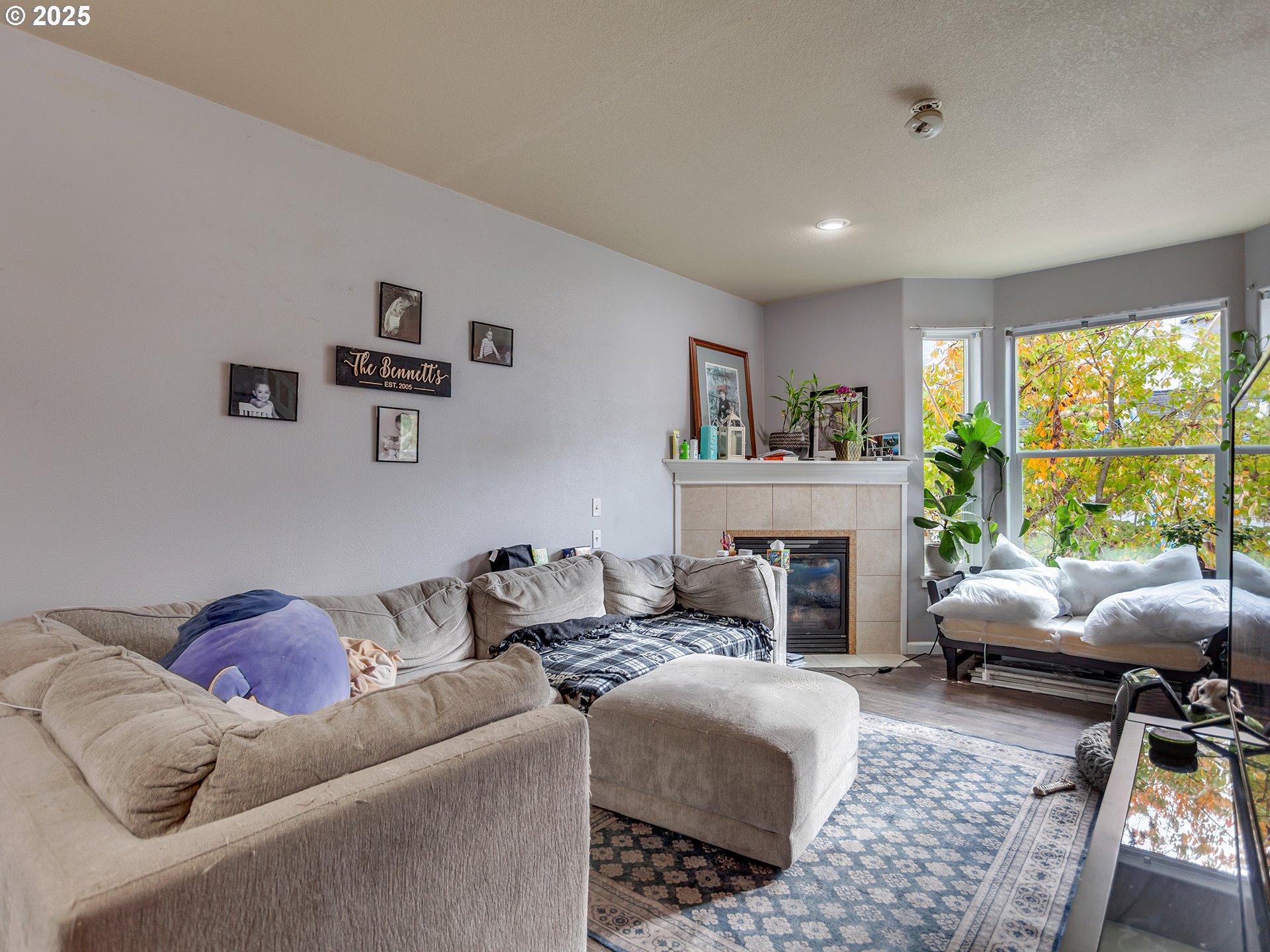 7817 Southwest Brookline Lane Portland, OR 97224 - Photo 5 of 13 a living room with furniture and a fireplace