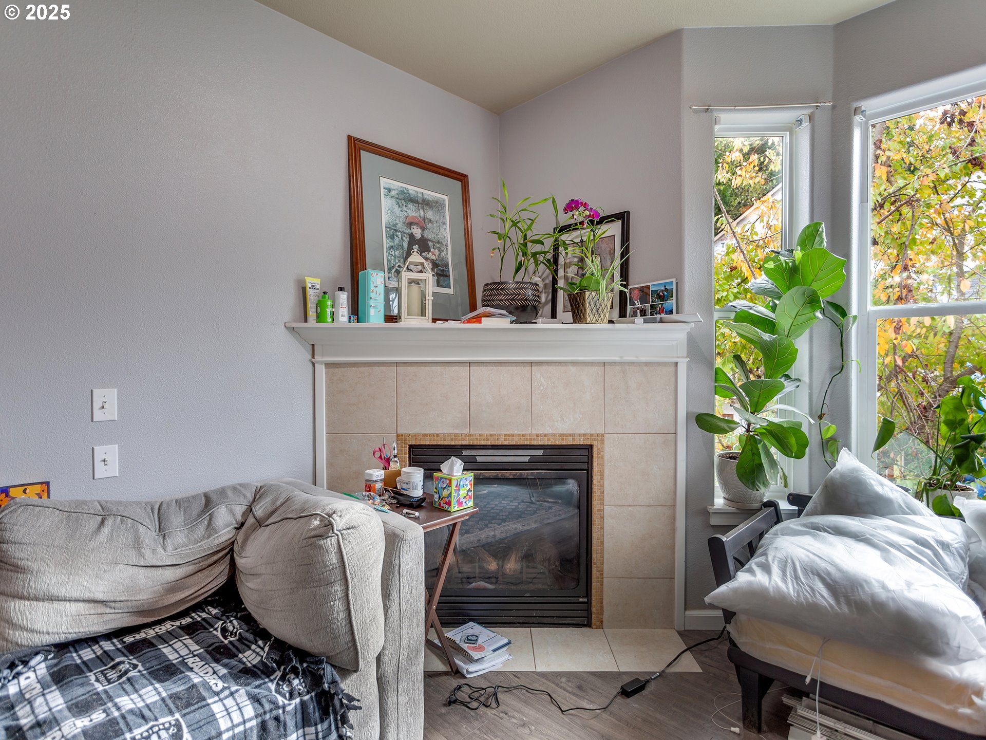 7817 Southwest Brookline Lane Portland, OR 97224 - Photo 6 of 13 a living room with furniture and a fireplace