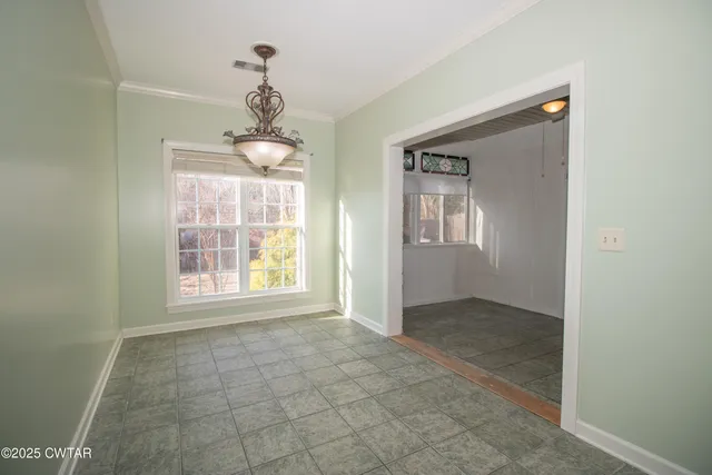 an empty room that has a window in it