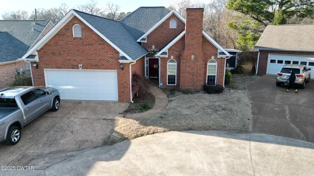 a view of a car park in front of house