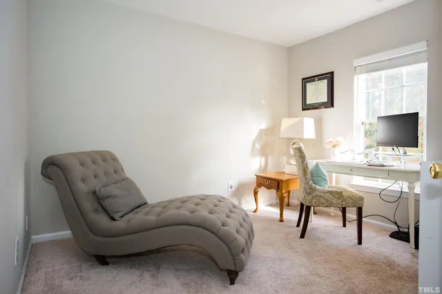 a living room with furniture and a chair