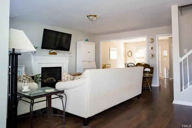 a living room with furniture fireplace and flat screen tv