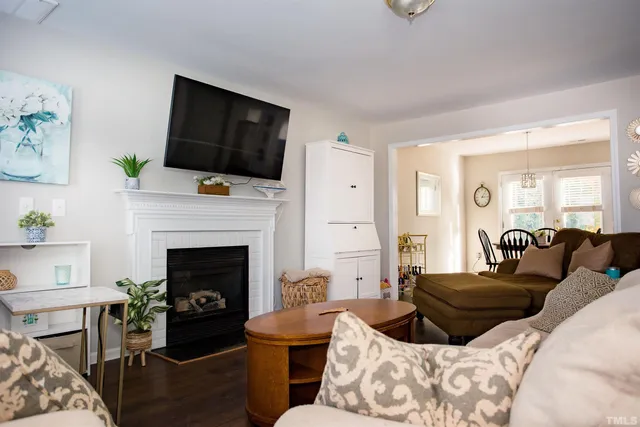 a living room with furniture a flat screen tv and a fireplace