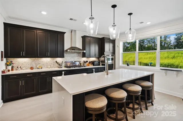a kitchen with stainless steel appliances a sink stove and refrigerator